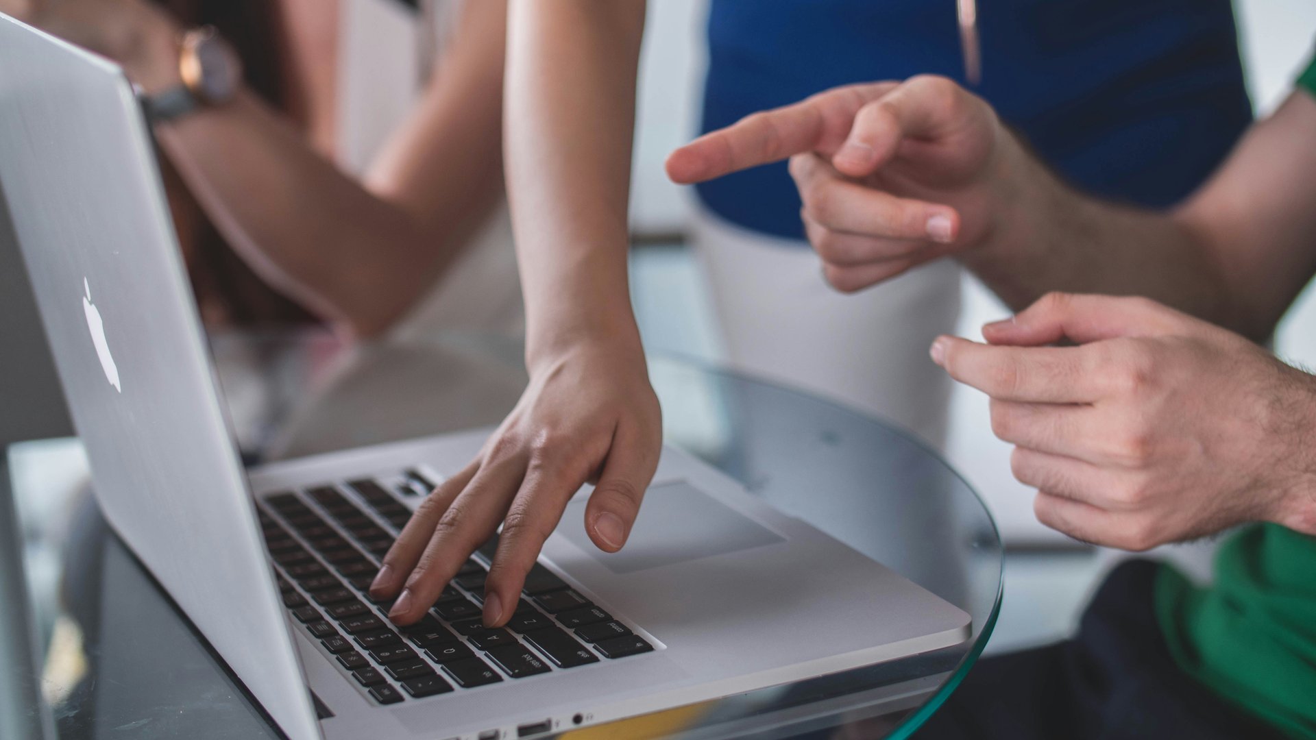 Team talking and pointing at a laptop | Giant Digital