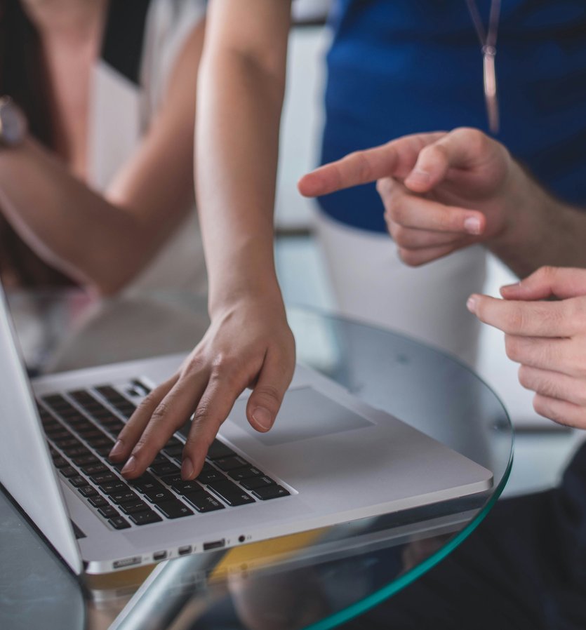 People pointing at a laptop